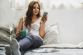 In this photo, a woman interacts with her smartphone.