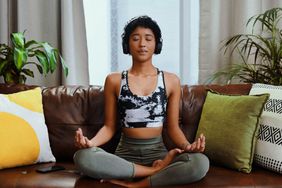 person meditating at home with free meditation apps