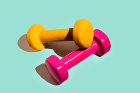 Small pink and yellow dumbbells against a light blue background