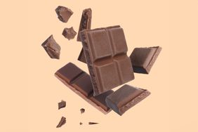 pieces of a chocolate bar on a light peach background