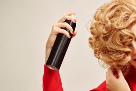 woman using hairspray