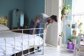 hipster man with beard making a bed