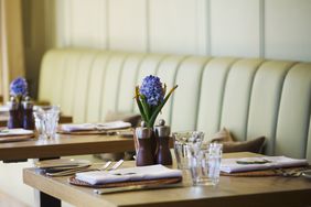 Tables set in the dining room at a boutique hotel in Gloucestershire.