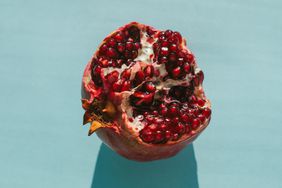 Ripe halved fresh pomegranate in bright sunlight