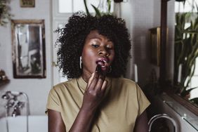 woman getting ready in the morning, putting on lipstick