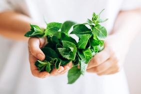 Woman holding a bunch of fresh mint