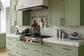 Kitchen with sage green cabinets and black hardware