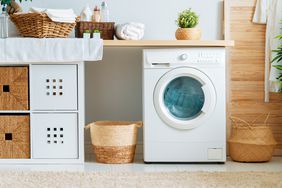 Interior of a real laundry room with a washing machine at home