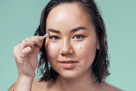 woman plucking eyebrows