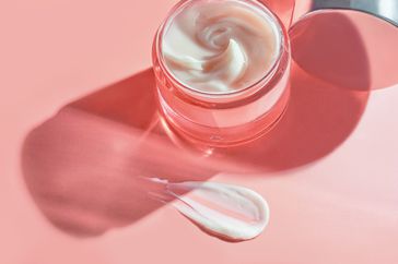 Refreshing Hydration Water Cream or Hand Cream on natural pastel pink colour background. Smudged makeup emulsion cream smear, Hair Mask and Skincare Moisturizer smudge, cosmetics product and paint strokes. Various natural Smears of cream, gel and serum