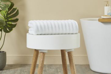 Mainstays Performance Textured Bath Towel on a bench in the bathroom