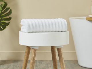 Mainstays Performance Textured Bath Towel on a bench in the bathroom