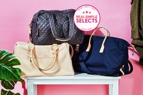 Three weekender bags we recommend on a white table in a pink room