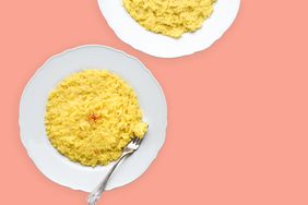 two plates of safron rice on a red background