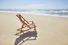 Empty beach chair on ocean shore