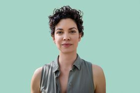 Woman with short, curly hair in front of a green background