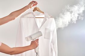 Woman steaming a shirt