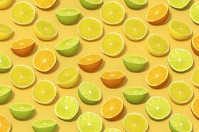 Lime and Orange Fruit Slices with Sunlight on Yellow Color Background